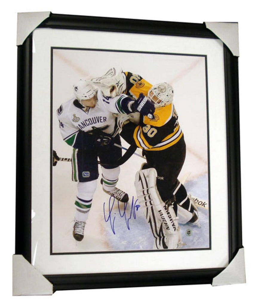 Autographed Tim Thomas 16x20 framed photo. The photo is of Tim pushing Burrows while in the goalie crease during the 2011 Stanley Cup